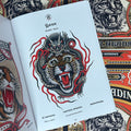 Inside pages of, 'Spitshading Tiger Heads', featuring a tiger head wrapped in a dragon, with red flames around it