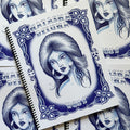 Front cover of Line Drawings Vol. 1 by Natasha DeLuna featuring a blue-ink sketch of a Chicana lady on a white background, with a frame and ornamental border and bold lettering.