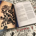 BJ Betts's The Graphic Art of Tattoo Lettering -- skull with dagger tattoo on page. 