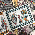 Inside pages of Greg Christian art featuring three styles of vases, each one decorated with tattoo imagery and with unique, colorful contents. The images are rendered in traditional style and colors. There is a checkered black and light blue border around the whole page.