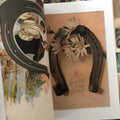 Inside pages of Vintage Postcards Vol. 4: Rock of Ages, Hands, Horseshoes featuring vintage color art of horse shoes..