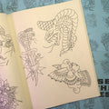 Inside pages of Jesse Strother - Lines featuring traditional line drawings of snakes and a woman.