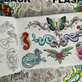 Inside pages of 'Flashback' by Aaron Bell featuring colorful flash designs such as a tribal design with a butterfly with green and blue wings at the center, a tribal design with intertwined snakes on opposite sides. a seahorse, a small dragon, and a pink flower with green leaves. The opposite page features the respective line drawings.