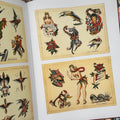 Inside pages of  Brooklyn Joe Lieber: American Tattoo Master book featuring traditional flash sheets in color showcasing flowers, pinups, and animals.