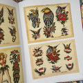 Inside pages of Brooklyn Joe Lieber: American Tattoo Master book featuring traditional flash sheets in color showcasing eagles and banners.