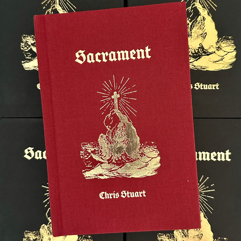 Front cover of 'Sacrament' by Chris Stuart featuring a depiction of a beaconing cross on a rock amidst the sea in gold foil on a dark red background.