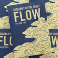 'Looking For The Right Flow Volume 2'  is a tattoo book about Japanese background studies by Fabio Gargiulo, with a blue hardcover, white text, and cloud imagery.