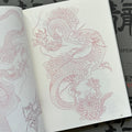 Inside pages of Garyotensei featuring a dragon in a twisty position, with chrysanthemums surrounding it