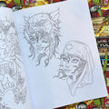 Inside pages of Shaun Topper's Line Drawings vol. 2 featuring line drawings of lady heads, one wearing a wolf head and the other a nurse headdress. 