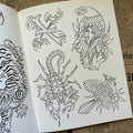 Inside pages of Line Drawings by Chris Stuart featuring various line drawings done in the traditional style, including a scorpion, a bird, and an eagle with a girl head on its back.