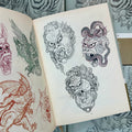 Inside pages of Alix Ge Sketches featuring sketches of various iterations of ape heads, such as Fudo ape, winged ape, and ape fighting a snap, amongst others.