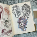 Inside pages of Alix Ge Sketches featuring sketches of various iterations of girl heads combined with wild cats.