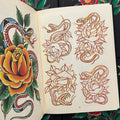 Inside pages of Keep It Real by Rinto featuring sketches and a full color drawing of snakes and roses.