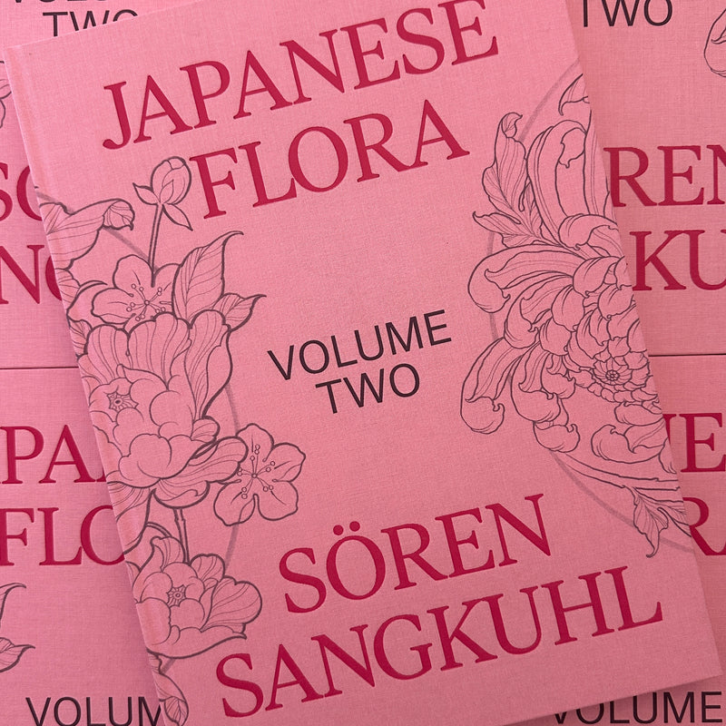 Front cover of Japanese Flora Vol. 2 by Sören Sangkuhl featuring a pink cloth cover with bold lettering and flower sketches.