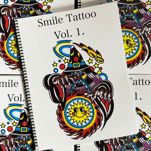 Front cover of Smile Tattoo Vol. 1 featuring a traditional style color image of a wizard conjuring a fireball with a smiley sun in the center.