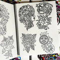 Inside pages of Smile Tattoo Vol. 1 featuring line drawings in the traditional style including a girhead, a rose, a tiger, a chrysanthemum, and a sun and moon in space.