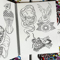Inside pages of Smile Tattoo Vol. 1 featuring line drawings in the traditional style including a dragon head, a skull and snake, and a jackalope.