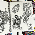 Inside pages of Smile Tattoo Vol. 1 featuring line drawings including a tribal sun, a tiger,  a panther in space, and a mouse smoking a pipe.