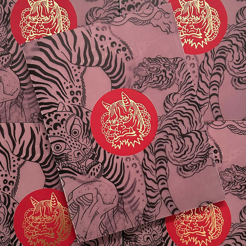 Front cover of Drawing for Tattoos Vol. 1 by Chris O'Donnell featuring a vellum cover with line drawings of tigers and an embossed hannya in the middle.
