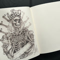 Inside pages of OG Abel Sketchbook featuring a sketch of a stylized version of death wearing a crown of bones.