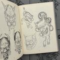Inside pages of Inkumaku by Salvio featuring line drawings of hannya masks.