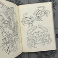 Inside pages of Inkumaku by Salvio featuring line drawings of heikegani (Samurai crab).