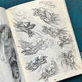 Inside pages of unrefined by Evan Griffiths featuring line drawings and sketches of dragon heads.