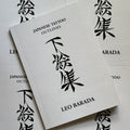 Front cover of Japanese Tattoo Outlines by Leo Barada featuring a bold font and Japanese symbols in black on a simple, light grey background.