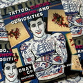 Front cover of Tattoo Catalogue 2024 featuring an illustrations of a man with numerous traditional tattoos, including a ship, a dragon, pinups, and various other designs. Behind him are flash sheets of other traditional designs.