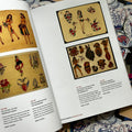 Inside pages of The Tattoo Catalogue 2024 featuring vintage tattoo flash sheets depicting a range of traditional imagery including pinups, hearts, and military motifs.