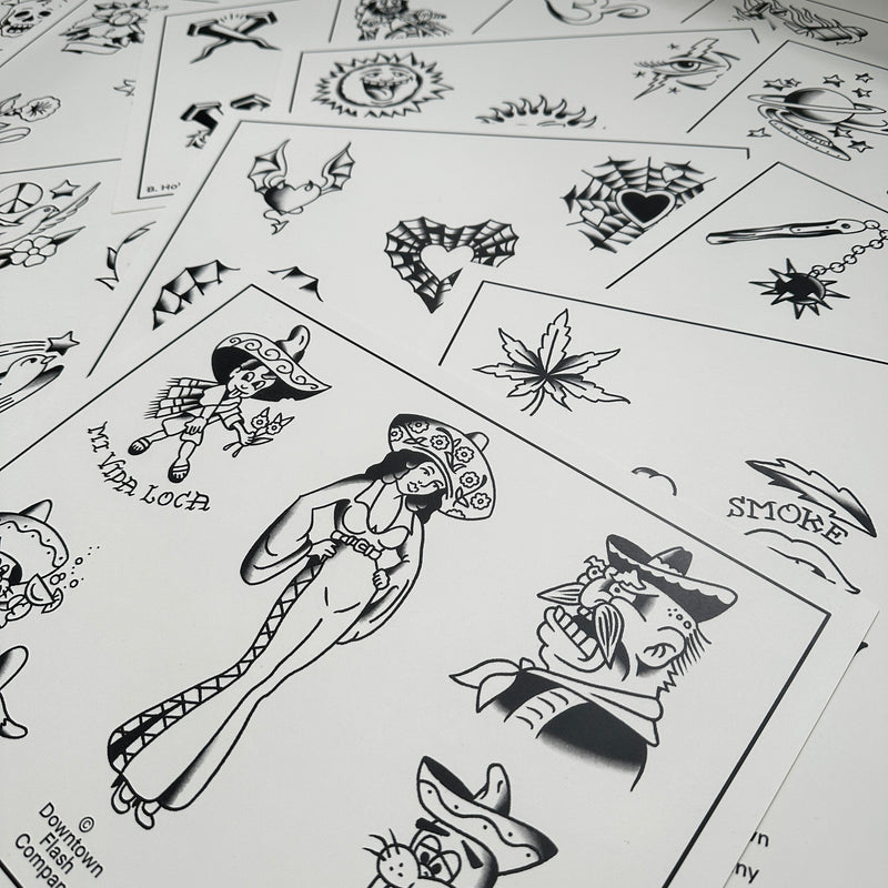 a selection of sheets of Buddy Holiday flash spread out, featuring a mexican lady, spiderweb hearts, a mace, suns and planets, doves, leaves, and much more. All painted in traditional style and black ink.