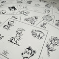 a selection of sheets of Buddy Holiday flash spread out featuring polar bears, roses and peonies, skulls, ghosts, and lady heads. All painted in traditional style and black ink.