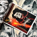 Inside pages of BD 42, featuring a skull in a cape, holding a flaming torch, with a red frame border.