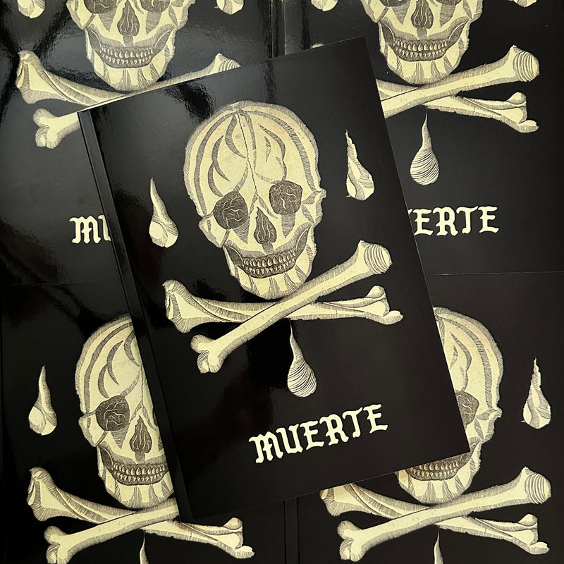 Front cover of 'Muerte', featuring a cream skull and crossbones with teardrops coming down in an etching style. 