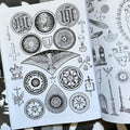 Inside pages of 'Cultish', featuring circular symbols with flowers in the center, star formations, a falcon, crosses on the edge of the paper with a lamb and a dragon.