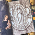 Inside pages of 'Virgin Mary', featuring a charcoal drawing of the virgin mary crossing her arms and being surrounded by angels in the sky.