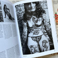 Inside pages of, 'Tattoo', featuring a photo of a woman with full arm sleeves, a stomach tattoo that says 'Rusty', two thigh tattoos, in a leopard print bikini