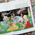 Inside pages of, 'Yokai Museum', featuring a scene of Yokai hanging out together at night in the grass wearing robes and telling ghost stories while cooking and sharing food 