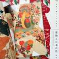 Inside pages of, 'Kimono and the Colors of Japan', featuring a light yellow kimono with embroidered phoenix, butterflies, and flowers in many colors