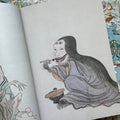 Inside pages of, 'Yokai', featuring a demon lady with long black hair in a purple robe eating a bowl of ramen with chopsticks