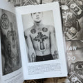 Inside pages of, 'Russian Criminal Tattoo Police Files Vol. 1', featuring torso tattoos of a crucifixion, and two circular frames with portraits inside, side by side, of a woman and a man