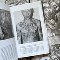 Inside pages of, 'Russian Criminal Tattoo Police Files. Vol 1', featuring a Russian prisoner with torso tattoos of angels, a cross in the middle, the virgin mary, christ in heaven, and a prayer in latin