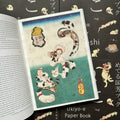 Inside pages of, 'Cats by Kuniyoshi', featuring various cats laying down to spell out Japanese characters