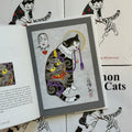 Inside pages of Horitomo, 'Monmon Cats', featuring a cat with a Hannya and clouds back piece, holding a purple tassel in it's mouth