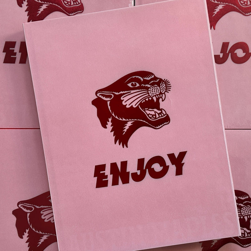 Front cover of Austin Maples, 'Enjoy', featuring a pink background with a hot pink embossed panther head and the word Enjoy, on a clear white cover