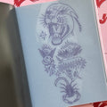 Inside pages of Austin Maples, 'Enjoy', featuring line drawings on a clear page of a panther head, a sacred heart, a scorpion, and a baby angel.