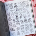 Inside pages of Austin Maples, 'Enjoy', featuring multiple tiny line drawings on a white page of skulls, sacred hearts, roses, wolf heads, panther heads, dog heads, crosses, and much more, all in traditional style.