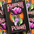 Front cover of Damon Conklin, 'Flower Power', featuring a purple skeleton hand holding up a purple peony, with green leaves, an orange spotlight background, and the words 'Flower Power', in pink & yellow colors