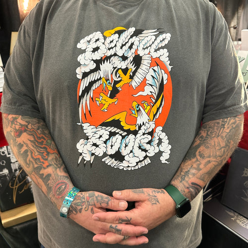 Front of a grey t-shirt with a Belzel Books eagle logo, of two eagles circling each other over a red sun, and the words Belzel Books shaped by clouds around them.