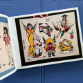 Traditional tattoo flash sheet from 'Everything That Burned' tattoo book by Jeff P. with pin-up girls, a black panther, Keep On Truckin', and other designs
